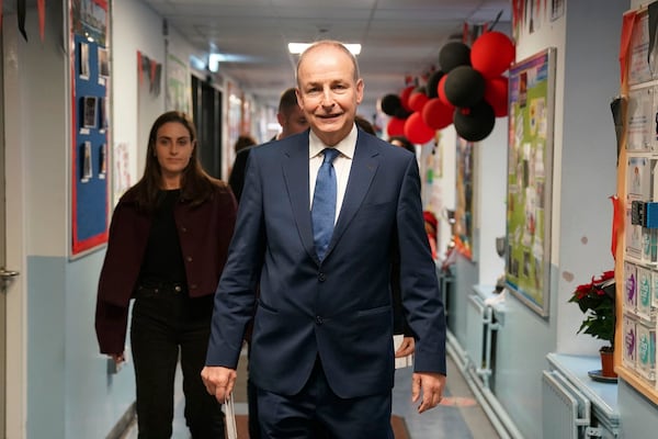 Minister for Foreign Affairs, and Minister for Defence and Fianna Fail leader Micheal Martin arrives to cast his vote at St Anthony's Boys' School, Beechwood Park, Ballinlough, Cork, as voters go to the polls for the 2024 General Election in Ireland, Friday, Nov. 29, 2024. (Jacob King/PA via AP)