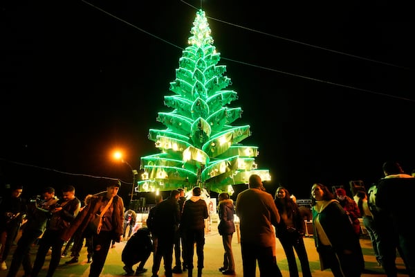 Syrian citizens gather outside Saydnaya Convent during the lighting of the Christmas tree, in Saydnaya town on the outskirts of Damascus, Syria, Tuesday, Dec. 24, 2024. (AP Photo/Hussein Malla)