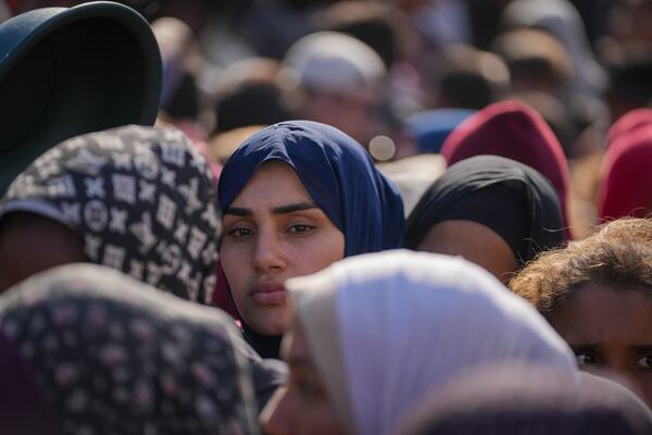 Women line up to receive donated food at a distribution center for displaced Palestinians in Deir al-Balah, Gaza Strip, on Dec. 17, 2024. (AP Photo/Abdel Kareem Hana)