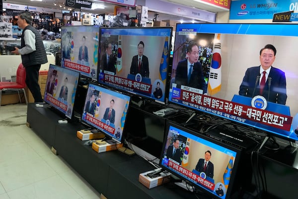 TV screens show the broadcast of South Korean President Yoon Suk Yeol's speech at the Yongsan Electronic store in Seoul, South Korea, Thursday, Dec. 12, 2024. (AP Photo/Ahn Young-joon)