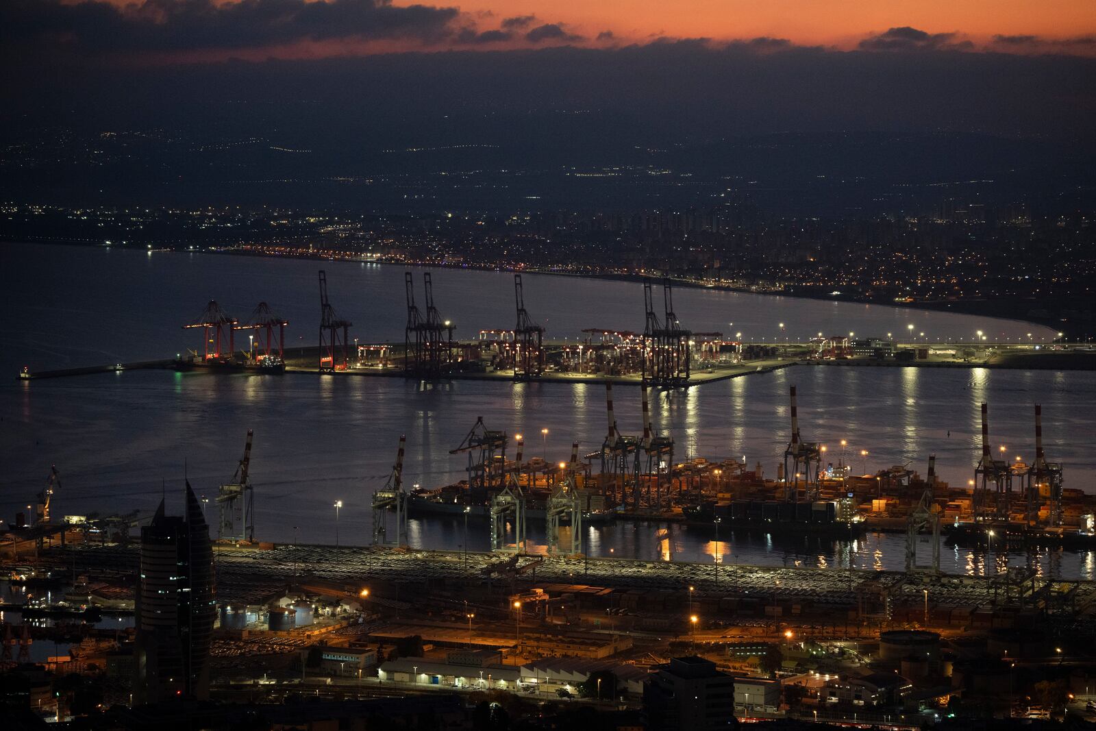 FILE - Gantry cranes used to load and unload cargo containers from ships sit stand during the dawn, in the port of Haifa, Israel, on Aug. 15, 2024. (AP Photo/Leo Correa, File)