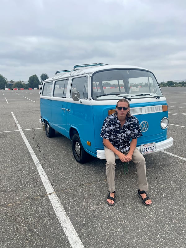 Preston Martin poses for a photo in front of his VW van on Aug. 21, 2022 in Irvine, Calif. (Cebrina Martin via AP)