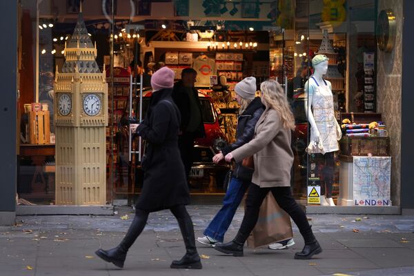 Shoppers pass a souvenir shop with a model of Big Ben in the window in Oxford Street in London, Friday, Nov. 15, 2024. (AP Photo/Kirsty Wigglesworth)