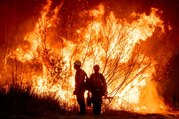 Fire crews battle the Kenneth Fire in the West Hills section of Los Angeles, Thursday, Jan. 9, 2025. (AP Photo/Ethan Swope)