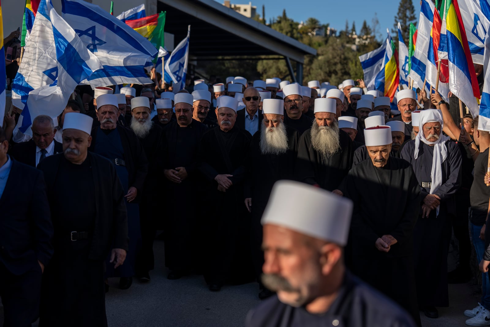 Men from the Israeli Druze minority mourn during the funeral of Israeli Colonel Ehsan Daxa in Daliyat al-Carmel, Israel, Monday, Oct. 21, 2024. Daxa, 41, was killed during Israel's ground operation in the Gaza Strip, where the Israeli army has been battling Palestinian militants in the war ignited by Hamas' Oct. 7 2023 attack into Israel. (AP Photo/Ariel Schalit)