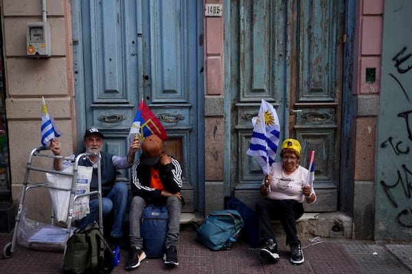 Supporters of Broad Front coalition presidential candidate Yamandu Orsi campaign one day ahead of the presidential run-off election, in Montevideo, Uruguay, Saturday, Nov. 23, 2024. (AP Photo/Natacha Pisarenko)