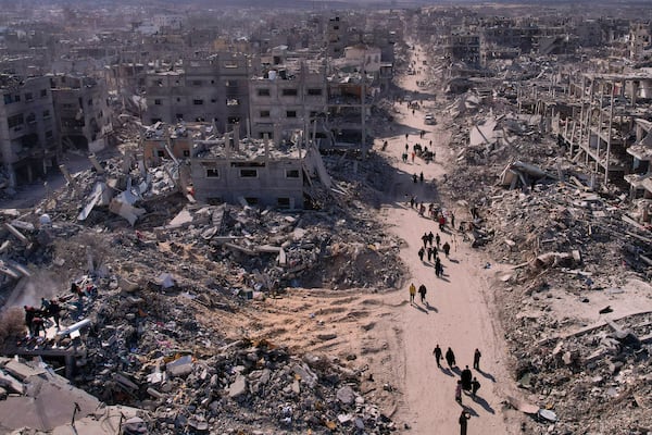 An aerial photograph taken by a drone shows displaced Palestinians returning to Rafah, a day after the ceasefire deal between Israel and Hamas came into effect, Gaza Strip, Monday, Jan. 20, 2025. (AP Photo/Mohammad Abu Samra)