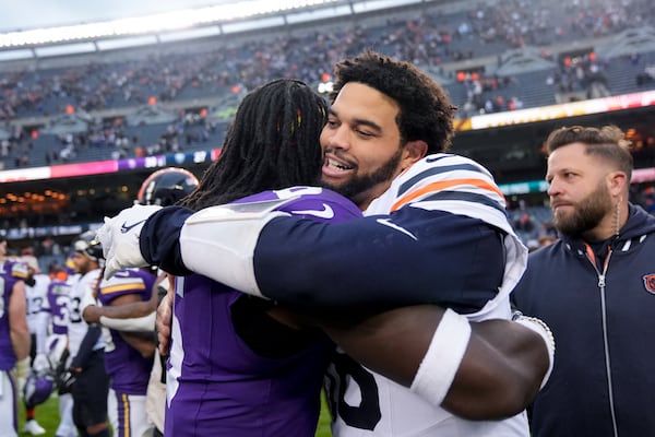 Chicago Bears quarterback Caleb Williams, right, hugs Minnesota Vikings linebacker Brian Asamoah II after an NFL football game Sunday, Nov. 24, 2024, in Chicago. (AP Photo/Erin Hooley)