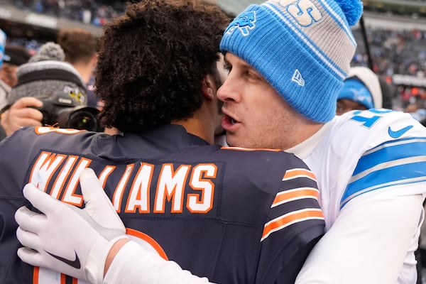 Chicago Bears quarterback Caleb Williams listens to Detroit Lions quarterback Jared Goff after an NFL football game Sunday, Dec. 22, 2024, in Chicago. (AP Photo/Erin Hooley)