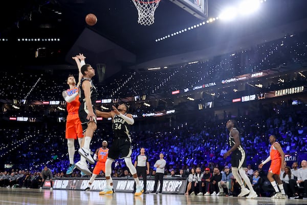 Oklahoma City Thunder center Isaiah Hartenstein (55) shoots against Milwaukee Bucks center Brook Lopez (11) and forward Giannis Antetokounmpo (34) during the first half of the championship game in the NBA Cup basketball tournament Tuesday, Dec. 17, 2024, in Las Vegas. (AP Photo/Ian Maule)