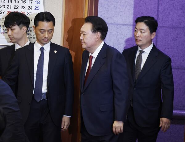 South Korea's impeached President Yoon Suk Yeol, second right, arrives to attend the fourth hearing of his impeachment trial over his short-lived imposition of martial law at the Constitutional Court in Seoul, South Korea, Jan.23, 2025. (Jeon Heon Kyun/Pool Photo via AP)