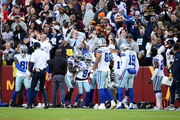 Dallas Cowboys wide receiver KaVontae Turpin (9) celebrates with teammates after scoring a 99-yard touchdown off a kickoff return during the second half of an NFL football game against the Washington Commanders, Sunday, Nov. 24, 2024, in Landover, Md. (AP Photo/Nick Wass)