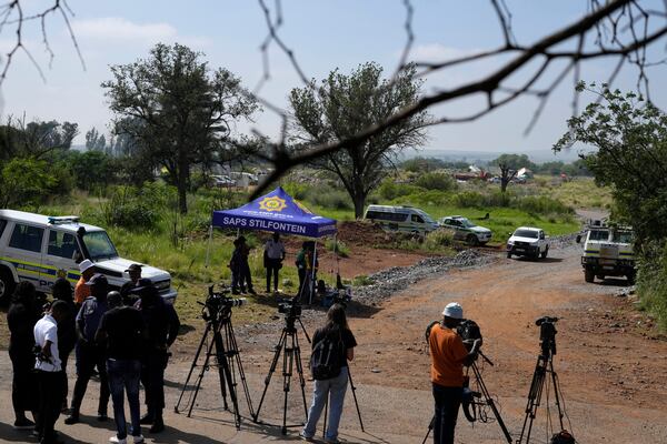 Journalists are seen during a stake-out at an abandoned gold mine, where miners were rescued from below ground, in Stilfontein, South Africa, Thursday, Jan. 16, 2025. (AP Photo/Themba Hadebe)