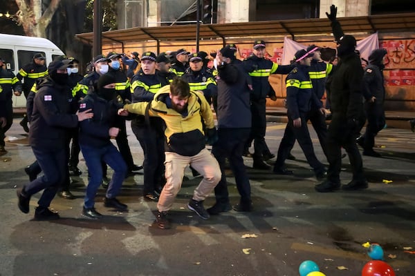 Police detain a protester in a street during a rally against the results of the parliamentary elections amid allegations that the vote was rigged in Tbilisi, Georgia, on Tuesday, Nov. 19, 2024. (AP Photo/Zurab Tsertsvadze)