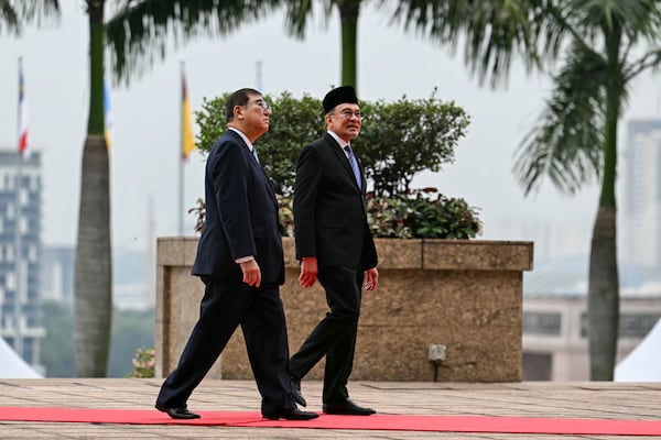 Malaysia's Prime Minister Anwar Ibrahim, right, and Japan's Prime Minister Shigeru Ishiba walk towards the prime minister's office after the welcoming ceremony in Putrajaya, Malaysia, Friday, Jan. 10, 2025. (Mohd Rasfan/Pool Photo via AP)