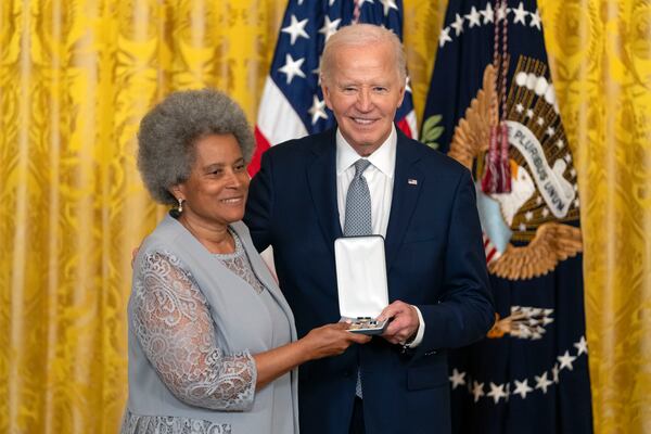 President Joe Biden awards the Presidential Citizens Medal to Rupa Redding-Lallinger on behalf of Louis Redding during a ceremony in the East Room at the White House, Thursday, Jan. 2, 2025, in Washington. (AP Photo/Mark Schiefelbein)