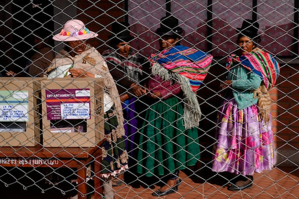 Aymara women wait in line to cast their ballots during judicial elections in Jesus de Machaca, Bolivia, Sunday, Dec. 15, 2024. (AP Photo/Juan Karita)