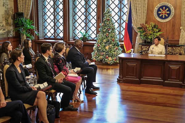 Philippine President Ferdinand Marcos Jr., right, meets with U.S. Defense Secretary Lloyd Austin, second right, and his delegation at the Malacanang Palace in Manila, Philippines Monday, Nov. 18, 2024. (AP Photo/Gerard Carreon, Pool)