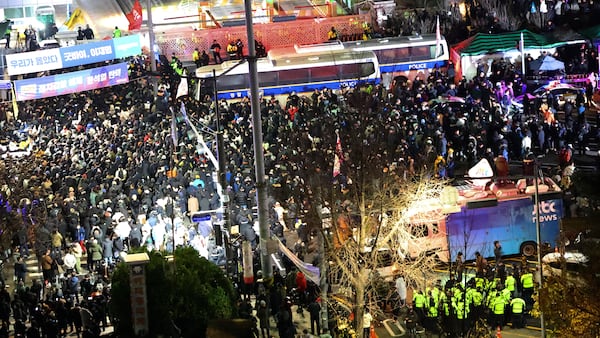 People gather to demand South Korean President Yoon Suk Yeol step down in front of the National Assembly in Seoul, South Korea, Wednesday, Dec. 4, 2024. (Kim Do-hoon/Yonhap via AP)