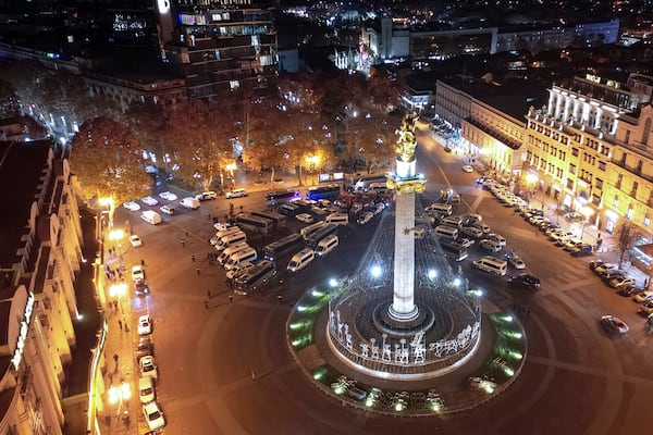 Police vehicles and ambulances are parked outside the parliament's building where people gathered to protest the government's decision to suspend negotiations on joining the European Union for four years in Tbilisi, Georgia, on Friday, Nov. 29, 2024. (AP Photo/Zurab Tsertsvadze)