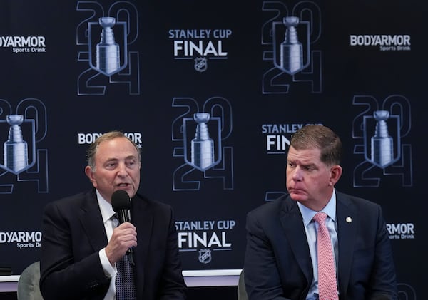 FILE - Gary Bettman, left, commissioner of the NHL, and Marty Walsh, right, executive director of the NHLPA, speak to the media ahead of Game 1 of the NHL hockey Stanley Cup Finals between the Florida Panthers and the Edmonton Oilers in Sunrise, Fla., June 8, 2024. (Nathan Denette/The Canadian Press via AP, file)