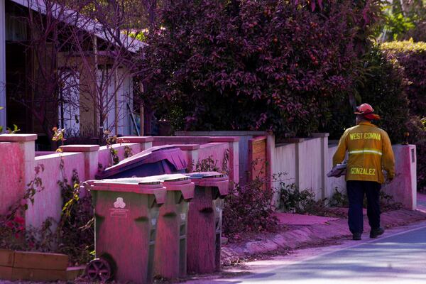 Retardant covers the front of a property after crews battled the Palisades Fire in Mandeville Canyon Monday, Jan. 13, 2025, in Los Angeles. (AP Photo/Richard Vogel)