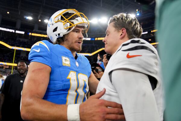 Los Angeles Chargers quarterback Justin Herbert (10) talks to Cincinnati Bengals quarterback Joe Burrow after an NFL football game Sunday, Nov. 17, 2024, in Inglewood, Calif. (AP Photo/Eric Thayer)