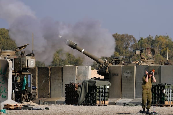 An Israeli soldier covers his ears as an artillery gunner fires into the Gaza Strip from a position in southern Israel, Thursday, Jan. 2, 2025.(AP Photo/Matias Delacroix)