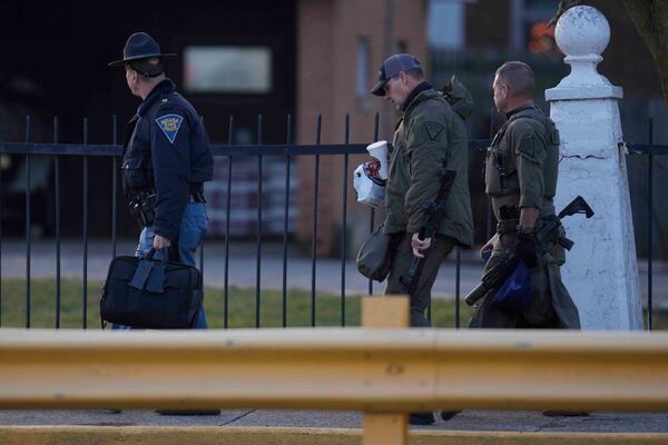 Indiana State Police officers enter Indiana State Prison where, barring last-minute court action or intervention by Gov. Eric Holcomb, Joseph Corcoran, 49, convicted in the 1997 killings of his brother and three other people, is scheduled to be put to death by lethal injection before sunrise Tuesday, Dec. 17, 2024, in Michigan City, Ind. (AP Photo/Erin Hooley)