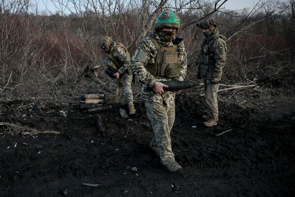 Ukrainian servicemen collect damaged ammunition on the road at the front line near Chasiv Yar town, in Donetsk region, Ukraine, Ukraine, Friday, Jan. 10, 2025. (Oleg Petrasiuk/Ukraine's 24th Mechanised Brigade via AP)