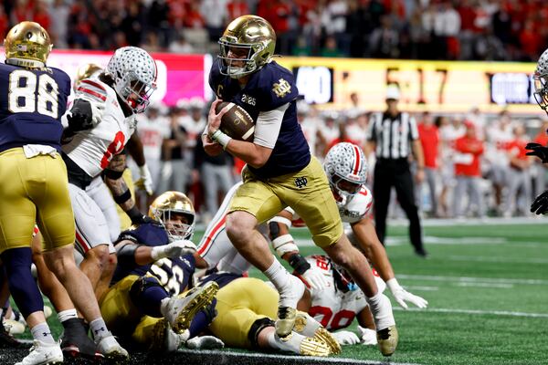 Notre Dame quarterback Riley Leonard runs for a touchdown against Ohio State during first half of the College Football Playoff national championship game Monday, Jan. 20, 2025, in Atlanta. (AP Photo/Butch Dill)