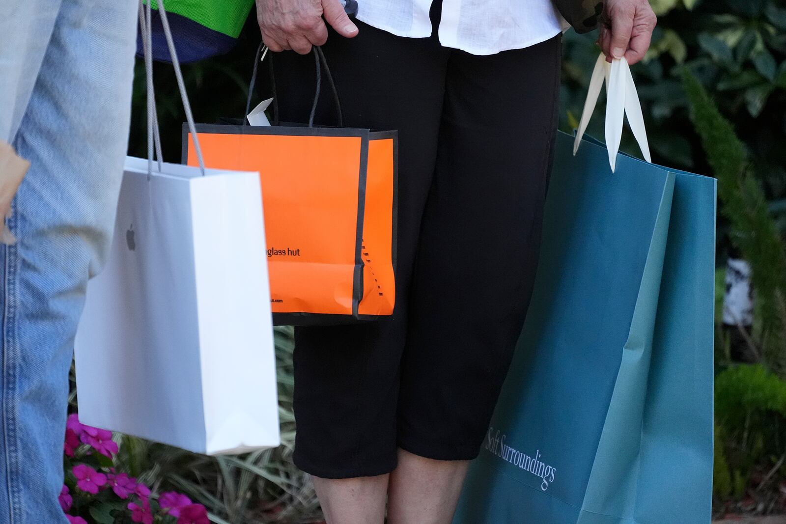 FILE - Shoppers hold bags after shopping in Bradenton, Fla., Feb. 9, 2024. (AP Photo/Gene J. Puskar. File)