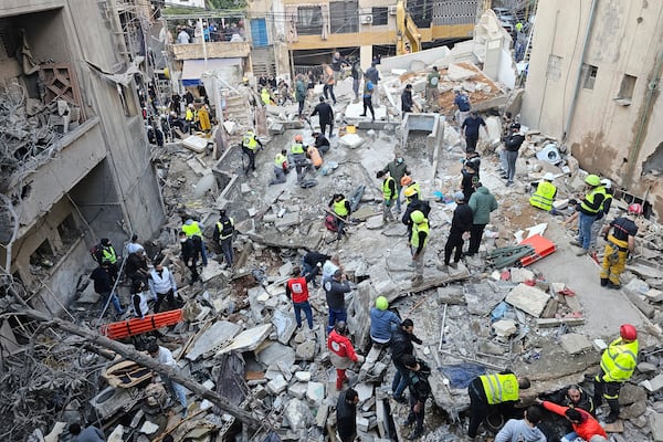 Rescuers search for victims at the site of an Israeli airstrike that targeted a building in Beirut, Lebanon, Tuesday, Nov. 26, 2024. (AP Photo/Hassan Ammar)