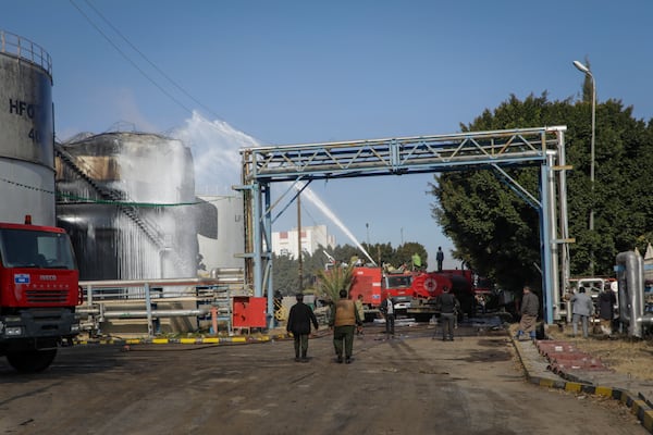 Firefighters work at the scene of an Israeli airstrike on the Haziz power station in southern Sanaa, Yemen, Thursday, Dec. 19, 2024. A series of intense Israeli airstrikes rocked Yemen's rebel-held capital and a port city early Thursday, killing at least nine people, according to officials. This attack came shortly after a Houthi missile targeted central Israel. (AP Photo/Osamah Abdulrahman)