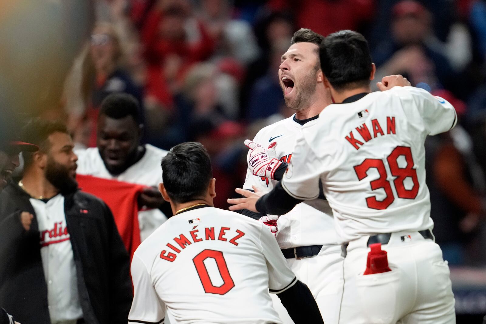 Cleveland Guardians' David Fry, second from right, celebrates with teammates after hitting a game-winning two-run home run against the New York Yankees during the 10th inning in Game 3 of the baseball AL Championship Series Thursday, Oct. 17, 2024, in Cleveland. The Guardians won 7-5. (AP Photo/Godofredo Vásquez )