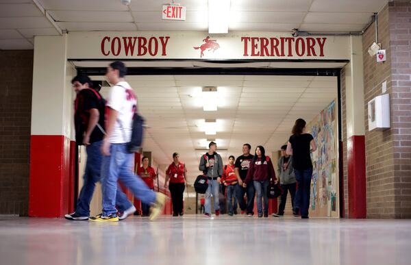 FILE - Premont High School students pass through the hall during a class change, Friday, Feb. 22, 2013, in Premont, Texas. (AP Photo/Eric Gay, File)