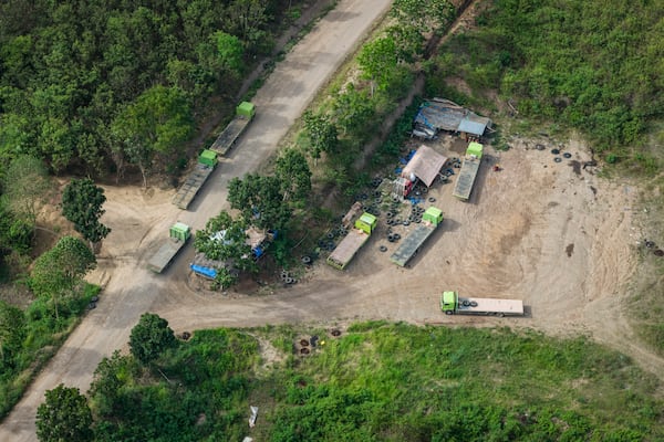 Trucks are parked near a road leading to areas of wood pellet production companies in Pohuwato, Gorontalo province, Indonesia, Tuesday, Oct. 22, 2024. (AP Photo/Yegar Sahaduta Mangiri)