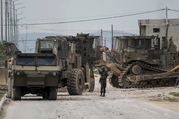 Israeli army vehicles are seen during a military operation in the West Bank city of Jenin, Wednesday, Jan. 22, 2025. (AP Photo/Majdi Mohammed)