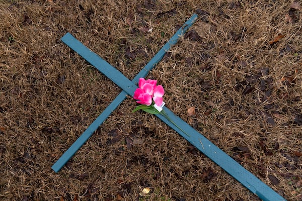 A cross is seen at a makeshift memorial for the victims of the plane crash in the Potomac River Friday, Jan. 31, 2025, in Arlington, Va. (AP Photo/Jose Luis Magana)