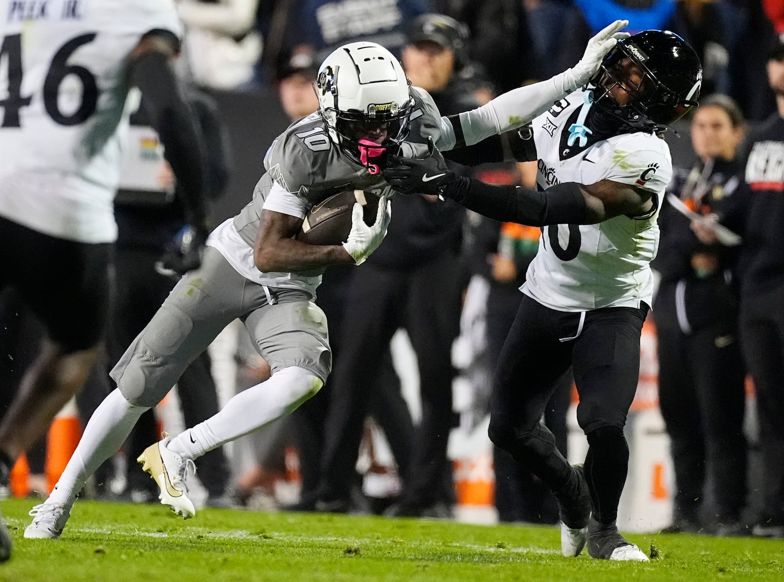 Colorado wide receiver LaJohntay Wester, left, avoids a tackle by Cincinnati defensive back Derrick Canteen in the second half of an NCAA college football game Saturday, Oct. 26, 2024, in Boulder, Colo. (AP Photo/David Zalubowski)