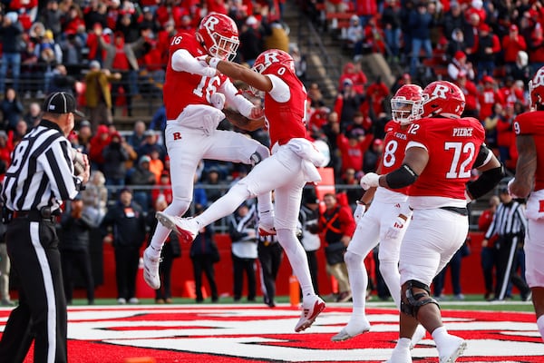 Rutgers quarterback Athan Kaliakmanis (16) celebrates his rushing touchdown against Illinois with wide receiver Dymere Miller (0) during the first half of an NCAA college football game, Saturday, Nov. 23, 2024, in Piscataway, N.J. (AP Photo/Rich Schultz)