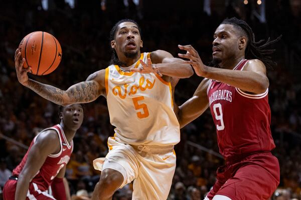 Tennessee guard Zakai Zeigler (5) drives for a shot past Arkansas forward Jonas Aidoo (9) during the first half of an NCAA college basketball game Saturday, Jan. 4, 2025, in Knoxville, Tenn. (AP Photo/Wade Payne)