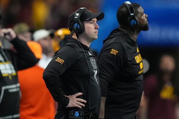 Arizona State head coach Kenny Dillingham, center, watches play against Texas during the first half in the quarterfinals of a College Football Playoff, Wednesday, Jan. 1, 2025, in Atlanta. (AP Photo/Brynn Anderson)