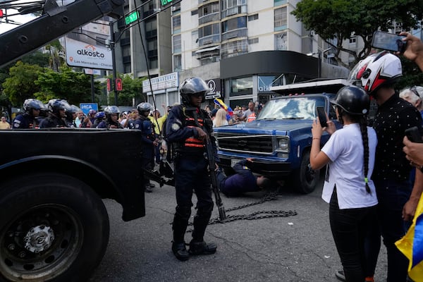 Police take possession of the truck from which opposition leader Maria Corina Machado addressed supporters at a protest in Caracas, Venezuela, Thursday, Jan. 9, 2025, the day before President Nicolas Maduro's inauguration for a third term. (AP Photo/Ariana Cubillos)