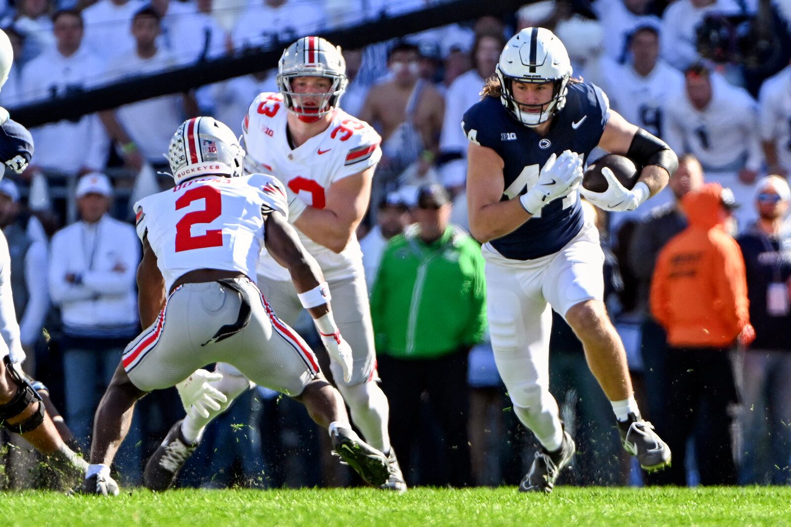 Penn State tight end Tyler Warren (44) looks to elude Ohio State safety Caleb Downs (2) during the first quarter of an NCAA college football game, Saturday, Nov. 2, 2024, in State College, Pa. (AP Photo/Barry Reeger)