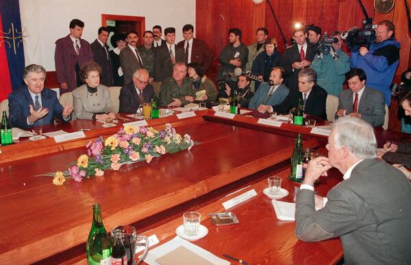 FILE - Former President Jimmy Carter, right, and Bosnian Serb leader Radovan Karadzic, left, speak during their meeting in the Bosnian Serb stronghold city of Pale, Bosnia, Dec. 19, 1994. After his previous successful missions in North Korea and Haiti, Carter is in former Yugoslavia to try and break the deadlock in Bosnia's peace talks. (AP Photo/Michel Euler, File)