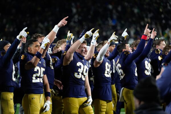 Notre Dame players celebrate after beating Indiana 27-17 in the first round of the NCAA College Football Playoff, Friday, Dec. 20, 2024, in South Bend, Ind. (AP Photo/Darron Cummings)