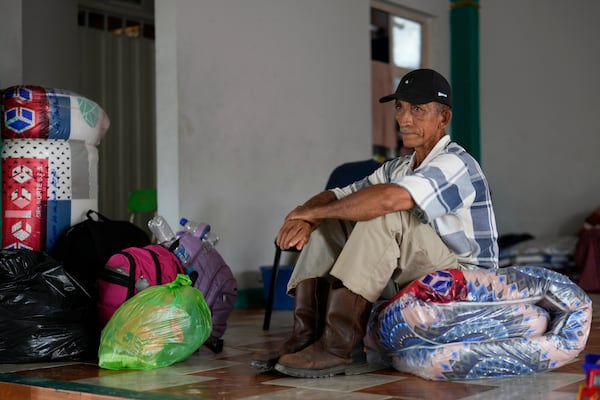 Jose Mejia sits inside a shelter for people displaced following guerrilla attacks that have killed dozens of people and forced thousands to flee their homes in Tibu, Colombia, Tuesday, Jan. 21, 2025. (AP Photo/Fernando Vergara)