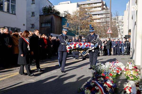 French President Emmanuel Macron, and Paris Mayor Anne Hidalgo, left, arrive to lay a wreath during a commemoration marking 10 years since an Islamist attack on the Charlie Hebdo satirical newspaper and the Hypercacher jewish supermarket, outside the weekly's former offices in Paris Tuesday Jan. 7, 2025. (Ludovic Marin, Pool via AP)