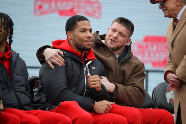 Ohio State linebacker Cody Simon, left, and defensive end Jack Sawyer react to the speeches during the National Championship celebration at Ohio Stadium in Columbus, Ohio, Sunday, Jan. 26, 2025. (AP Photo/Joe Maiorana)